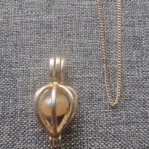 Nautural Pearl in cage Pendant on 18" chain 